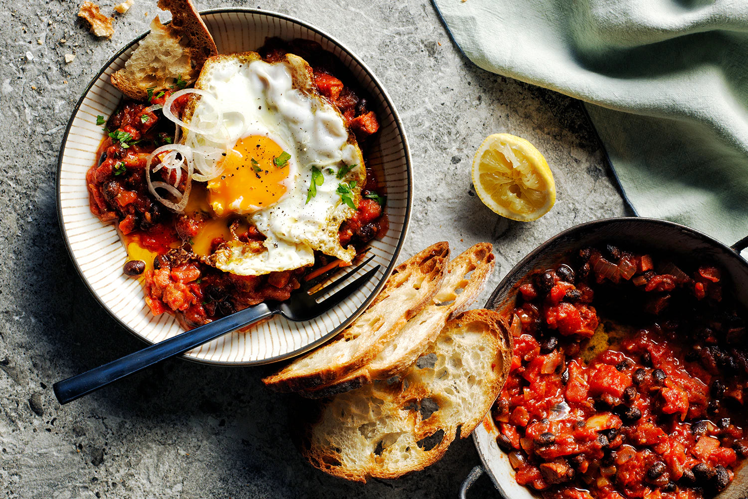 Spiced black beans, chorizo, fried eggs and herbs